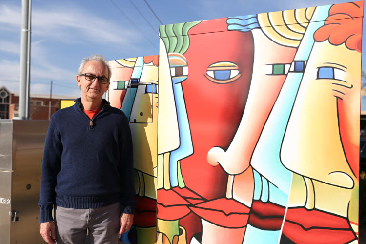 Artist Lynn Kelly poses with his Utility Box Art 