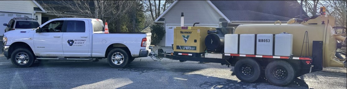 second sight systems truck with trailer attached materials in a neighborhood