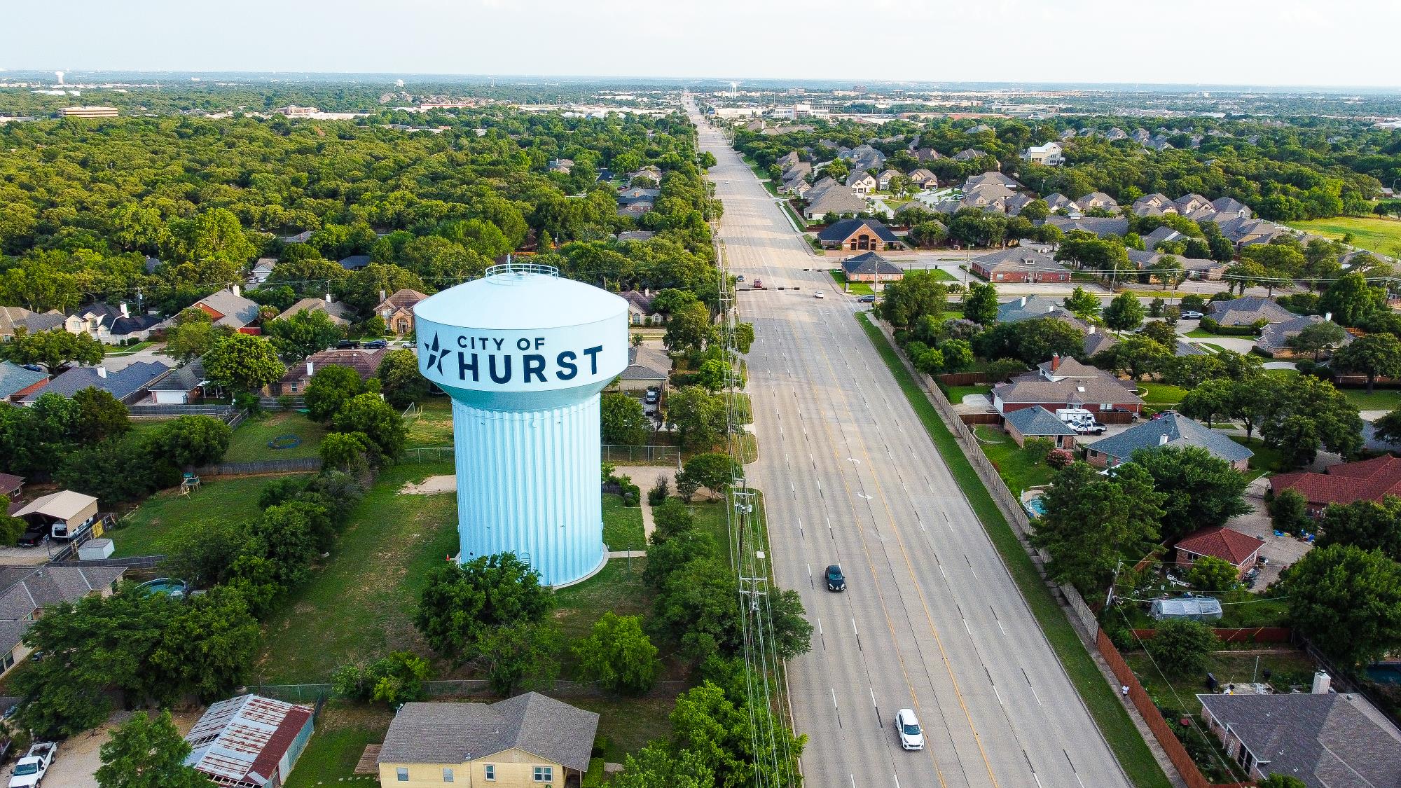 image of city of hurst water tower and houses and streets